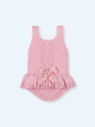 Baby romper with skirted ruffle and bow